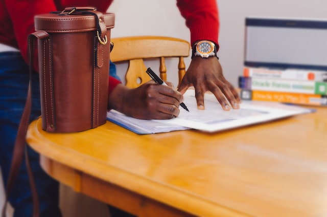 Person signing papers for hard money loan in Houston