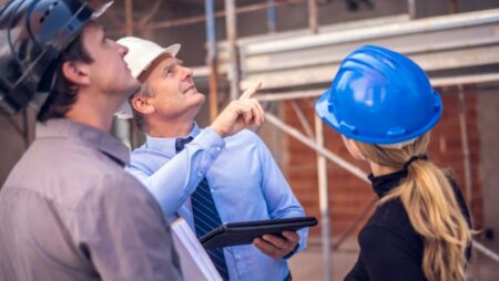 Real estate investors in hard hats considering hard money loan in Houston